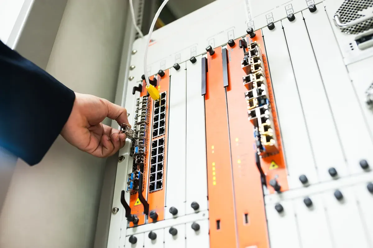 Technician connecting patch cables to a network switch