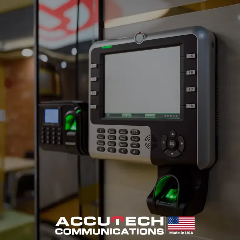 Wall-mounted biometric time clock and fingerprint reader with keypads glowing green