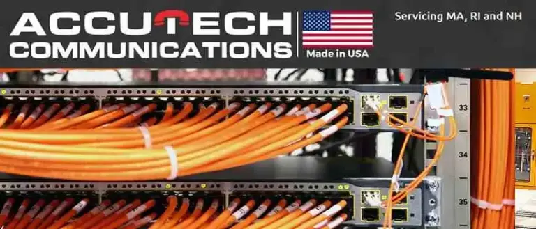 Orange fiber patch cords bundled and plugged into network switches in a rack