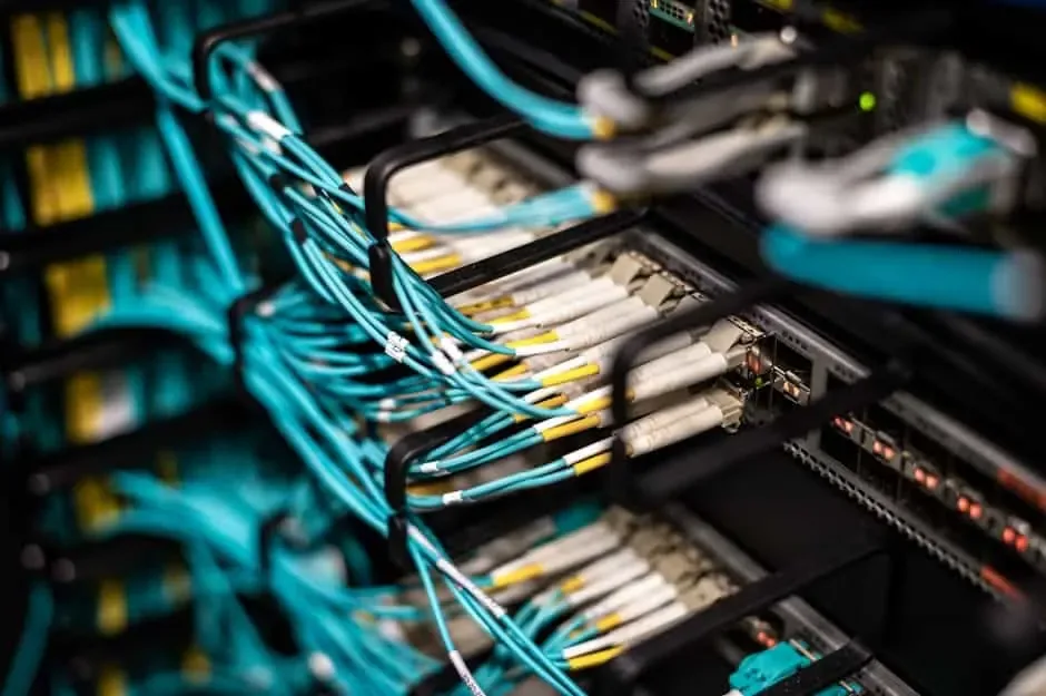 Aqua fiber patch cords with duplex connectors routed through rack management fingers